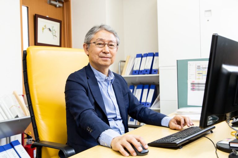Takaaki Kimura, Managing Partner of Tokyo-based IP law firm, Kimura & Partners. Sitting at his desk.